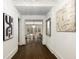 Elegant hallway featuring hardwood floors, crisp white walls, and tasteful artwork at 591 E Morningside Ne Dr, Atlanta, GA 30324