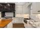 Spacious kitchen featuring stone countertops, a farmhouse sink, and ample cabinet space at 591 E Morningside Ne Dr, Atlanta, GA 30324
