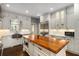 Beautiful kitchen featuring white cabinets, a butcher block island, and stainless steel appliances at 591 E Morningside Ne Dr, Atlanta, GA 30324