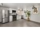 Basement kitchen area features stainless steel appliances, white cabinets, and tile floors at 591 E Morningside Ne Dr, Atlanta, GA 30324