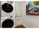Functional laundry room with stacked washer and dryer and a small sink at 591 E Morningside Ne Dr, Atlanta, GA 30324