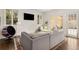 Cozy living room with a comfortable grey sofa and French doors leading to the exterior at 591 E Morningside Ne Dr, Atlanta, GA 30324