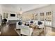 Open-concept living room with comfortable seating, a fireplace, and multiple French doors at 591 E Morningside Ne Dr, Atlanta, GA 30324