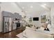 Bright, open-concept living space with modern kitchen, comfortable seating, and hardwood floors at 591 E Morningside Ne Dr, Atlanta, GA 30324