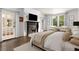 Spacious main bedroom featuring a fireplace, French doors, neutral color palette, and a seating area by the windows at 591 E Morningside Ne Dr, Atlanta, GA 30324