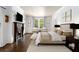 Cozy bedroom with a decorative fireplace, hardwood floors, and ample natural light at 591 E Morningside Ne Dr, Atlanta, GA 30324