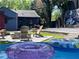 The backyard features a stock tank pool, fire pit, mural, and landscaping near the home at 727 Channing Nw Dr, Atlanta, GA 30318