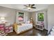 A bedroom featuring natural light, hardwood floors, a ceiling fan and fun toys at 727 Channing Nw Dr, Atlanta, GA 30318