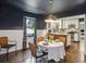 Cozy dining area with an open view to the modern kitchen, featuring elegant table setting at 727 Channing Nw Dr, Atlanta, GA 30318