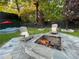 Cozy backyard area featuring a stone fire pit, outdoor seating, and a stock tank pool at 727 Channing Nw Dr, Atlanta, GA 30318