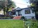 Charming one-story home with brick steps, manicured lawn and mature landscaping at 727 Channing Nw Dr, Atlanta, GA 30318
