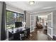 Home office with hardwood floors, a desk, and a view of the backyard, open to living room at 727 Channing Nw Dr, Atlanta, GA 30318