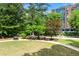 Lush backyard featuring mature trees, green lawn, and a walking path perfect for enjoying the outdoors at 130 26Th Nw St # 801, Atlanta, GA 30309