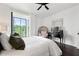 Bedroom featuring hardwood floors, ceiling fan, and view through a floor-to-ceiling window at 130 26Th Nw St # 801, Atlanta, GA 30309