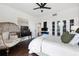 Bright bedroom with large windows, ceiling fan, dark floors, and stylish furnishings at 130 26Th Nw St # 801, Atlanta, GA 30309