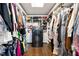 Walk-in closet with custom shelving and a built-in washer/dryer at 130 26Th Nw St # 801, Atlanta, GA 30309