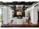 Stylish dining room with raised platform, dark wood floors, designer lighting, and black accent wall at 130 26Th Nw St # 801, Atlanta, GA 30309