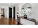 Elegant entryway with hardwood floors, decorative mirror, console and modern art at 130 26Th Nw St # 801, Atlanta, GA 30309