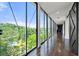 Hallway with floor-to-ceiling windows showcasing expansive views of lush treetops and blue skies at 130 26Th Nw St # 801, Atlanta, GA 30309
