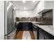 Galley kitchen featuring stainless steel appliances, granite countertops, and a striking backsplash at 130 26Th Nw St # 801, Atlanta, GA 30309
