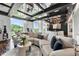 Bright living room features large windows, sleek finishes and a plush sectional sofa at 130 26Th Nw St # 801, Atlanta, GA 30309