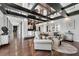 Open living space with dark wood floors, black beam ceiling, and view to dining and other living spaces at 130 26Th Nw St # 801, Atlanta, GA 30309