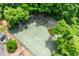 Aerial shot showcasing the tennis court surrounded by lush greenery and trees at 130 26Th Nw St # 801, Atlanta, GA 30309