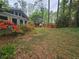 Lush backyard with vibrant landscaping and views of the house and surrounding trees at 2564 Wren Nw Ave, Duluth, GA 30096