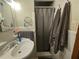 Compact bathroom featuring a pedestal sink and shower with gray towels at 2564 Wren Nw Ave, Duluth, GA 30096