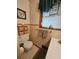 Bright bathroom features a toilet, vanity with sink and window at 2564 Wren Nw Ave, Duluth, GA 30096