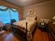 Cozy bedroom features hardwood flooring, a comfortable bed and bright natural lighting at 2564 Wren Nw Ave, Duluth, GA 30096