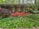 Cozy front porch featuring decorative iron supports and lush flowerbeds at 2564 Wren Nw Ave, Duluth, GA 30096