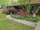 Close up of flowerbeds lining the front of this brick home with mature landscaping at 2564 Wren Nw Ave, Duluth, GA 30096