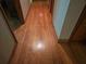 Hallway showcasing gleaming hardwood flooring and natural light between rooms at 2564 Wren Nw Ave, Duluth, GA 30096