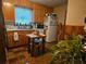 A cozy kitchen with honey oak cabinetry, a moveable island, and lots of natural light at 2564 Wren Nw Ave, Duluth, GA 30096