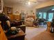 Spacious living room features comfortable seating, wood paneling and access to a sunroom at 2564 Wren Nw Ave, Duluth, GA 30096