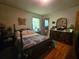Comfortable main bedroom with hardwood floors, a bed with dark wooden frame, and a dresser at 2564 Wren Nw Ave, Duluth, GA 30096