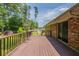 An empty back deck of a house, showing the wood texture, a partial view of the yard, and the back door at 29 Parkwood Ne Dr, Kennesaw, GA 30144