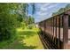 A view of the backyard from the side of the back deck, showing the grass and trees at 29 Parkwood Ne Dr, Kennesaw, GA 30144