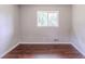 Cozy bedroom with one window providing sunlight and wood floors at 29 Parkwood Ne Dr, Kennesaw, GA 30144