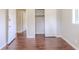 Bedroom featuring closet and entry doors with brown wood floors at 29 Parkwood Ne Dr, Kennesaw, GA 30144