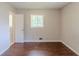 Cozy bedroom with an entry door and one window providing sunlight and wood floors at 29 Parkwood Ne Dr, Kennesaw, GA 30144