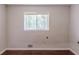 Cozy bedroom with wood-look flooring and a window that provides natural light at 29 Parkwood Ne Dr, Kennesaw, GA 30144
