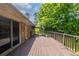 A spacious wooden deck, ideal for outdoor living and entertaining, overlooks a lush green backyard with mature trees at 29 Parkwood Ne Dr, Kennesaw, GA 30144