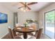 Dining area featuring a ceiling fan, a table with four chairs and a sliding glass door at 29 Parkwood Ne Dr, Kennesaw, GA 30144