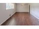 Open living room featuring hardwood floors and natural light from the large window at 29 Parkwood Ne Dr, Kennesaw, GA 30144
