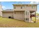 Back exterior of home features two stories, backyard, and covered porch at 642 Towering Pine Trl, Lawrenceville, GA 30045