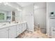 Bright bathroom featuring a double vanity, large mirror, and tile flooring at 642 Towering Pine Trl, Lawrenceville, GA 30045