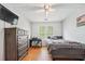 Comfortable bedroom with hardwood floors, a desk, and a large window at 642 Towering Pine Trl, Lawrenceville, GA 30045