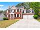Beautiful two-story red brick home featuring a two-car garage and well-kept front lawn at 642 Towering Pine Trl, Lawrenceville, GA 30045